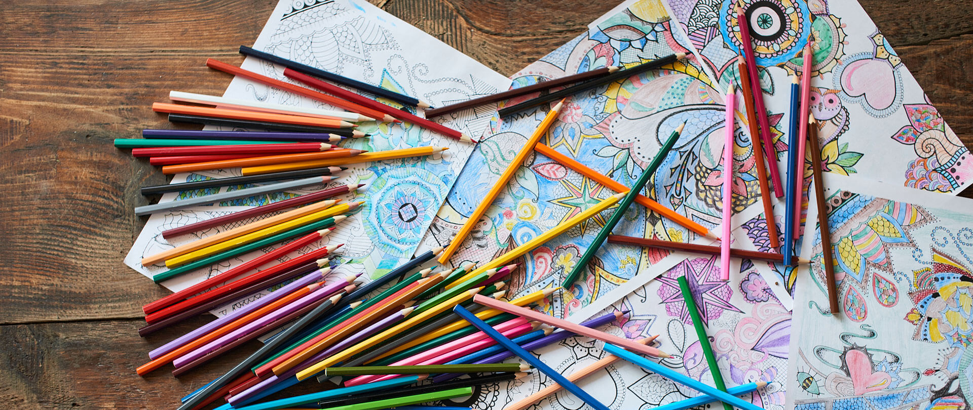Colored pencils and coloring sheets on a table