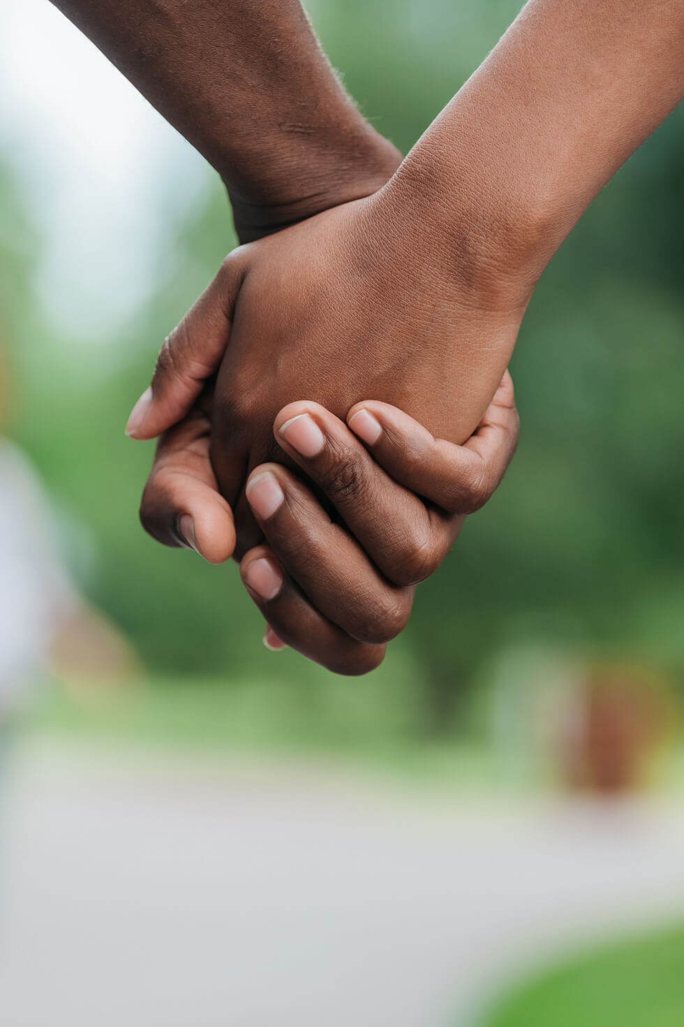 Couple holds hands.