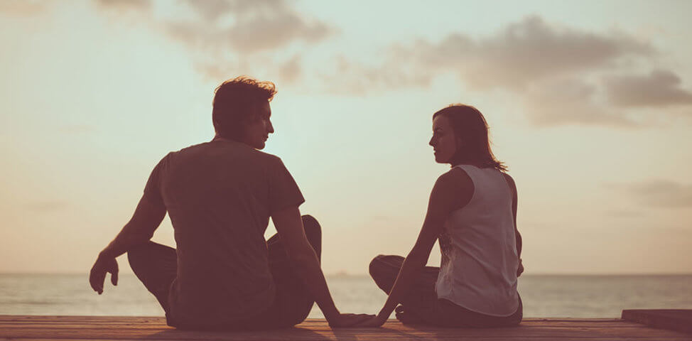 Couple talks together outdoors in nature