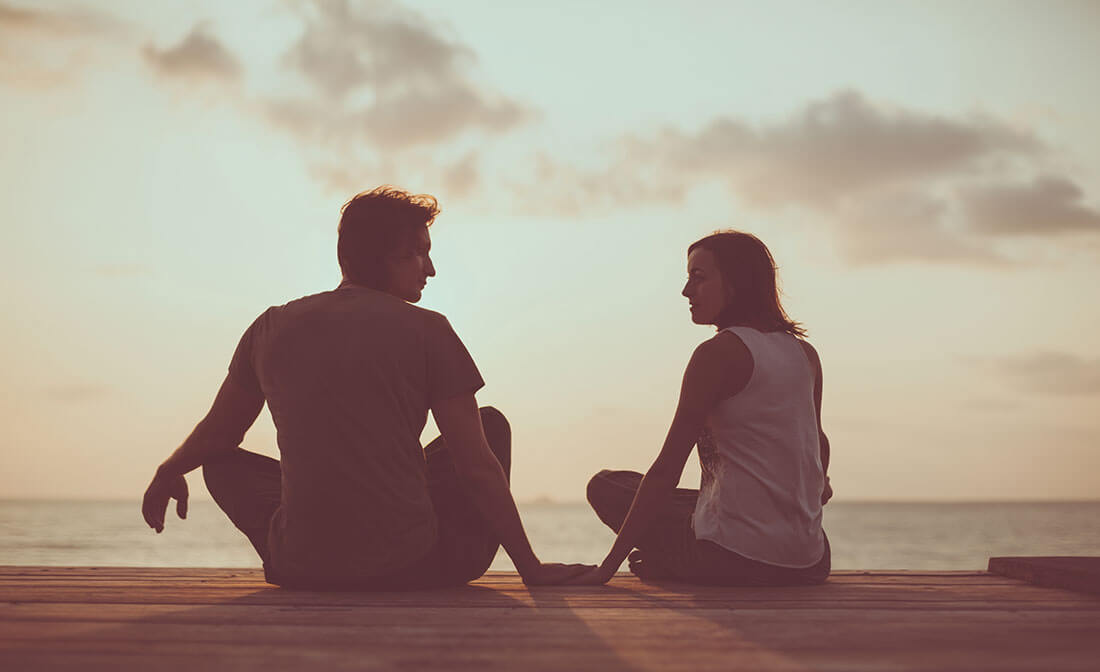 Couple talks together outdoors in nature
