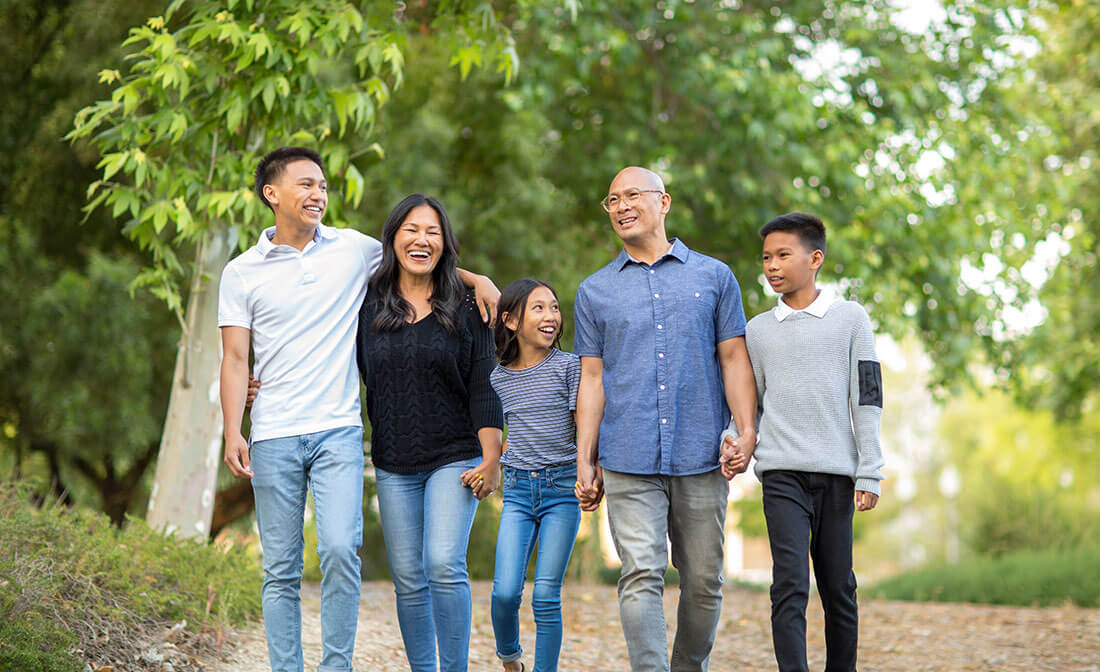 Family with older children go for a walk