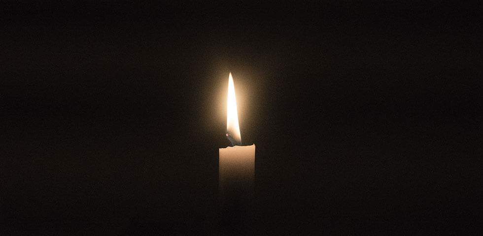 Candle burning in the dark.