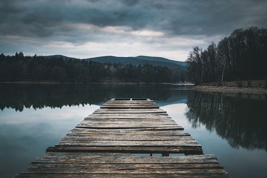 Wooden dock on a serene lake.