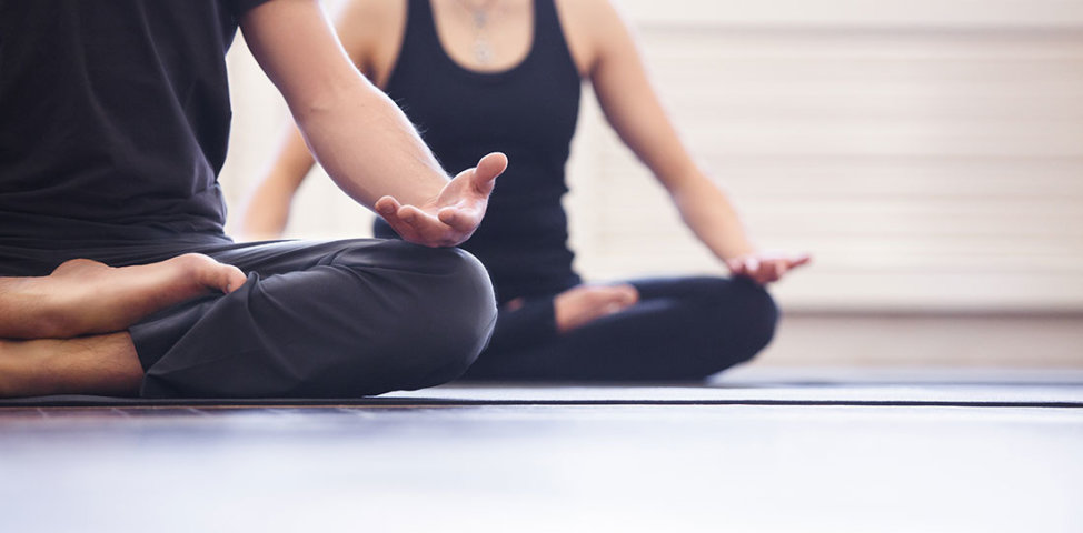 Man and woman doing gentle yoga for therapeutic benefits